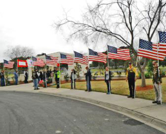 Patriot Guard members holding flags in a flag line at Houston National Cemetery
