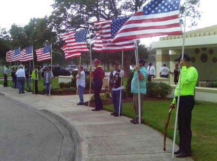 Patriot Guard members holding flags in a flag line at Houston National Cemetery
